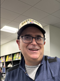 Picture of a man with glasses and a Steelers hat. 