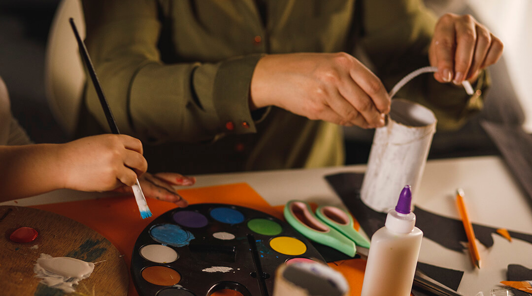 People working with paint, glue and other craft materials